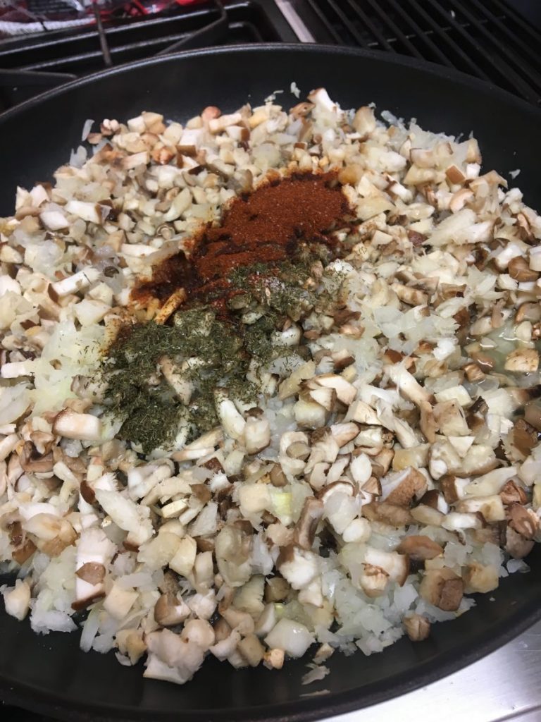 Add mushrooms and spices to onions
